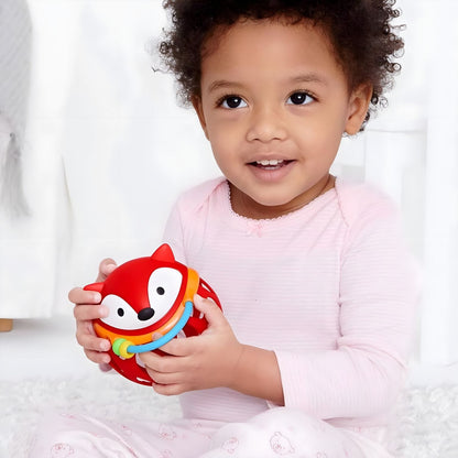 Skip Hop Red Fox Rattle Ball in the hands of babies in a moment of discovery