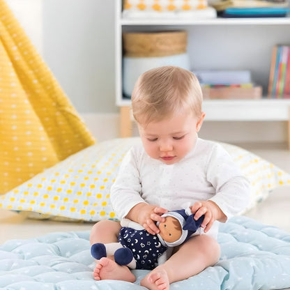 Baby with Corolle Blue Cloth Doll with Starry Dress in a soft play environment