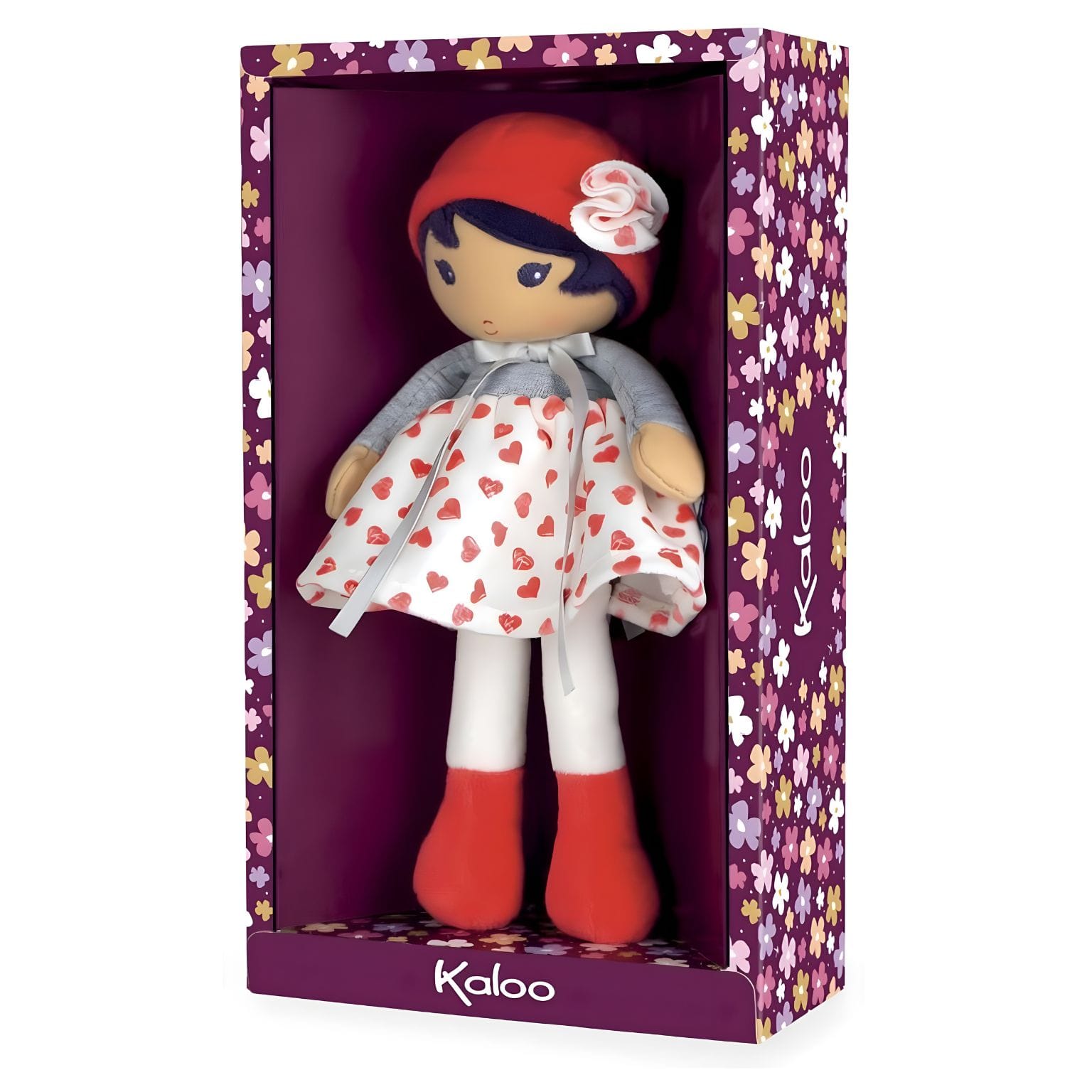 Boneca de Pano Jade da Kaloo com vestido branco de corações vermelhos, camisola cinzenta e gorro vermelho