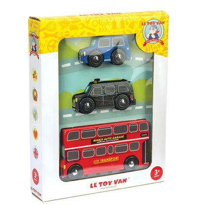 Child playing with Le Toy Van's London Vehicles wooden set with red bus, black taxi, and blue car