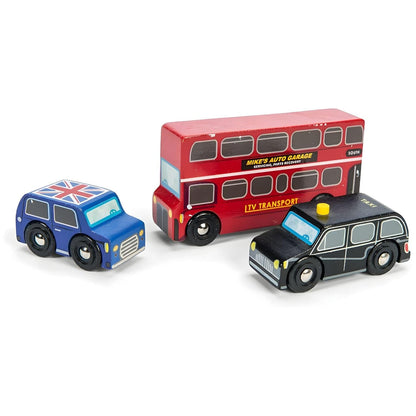 Child playing with Le Toy Van's London Vehicles wooden set with red bus, black taxi, and blue car