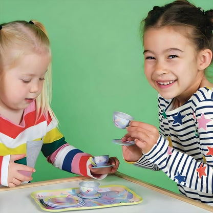 Children playing with a Musical Fantasy Tea Set in a colorful suitcase with unicorns and mermaids