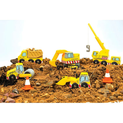 Child playing with Le Toy Van wooden construction vehicles, including truck, crane, excavator, loader, and cones.