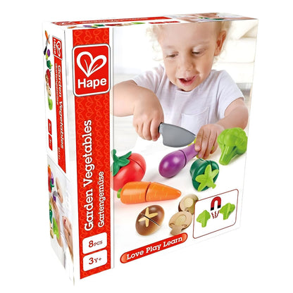Child playing with Hape wooden vegetable set and toy knife