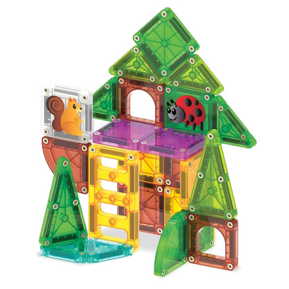 Child building with Magna-Tiles microMAGS Travel Tree House