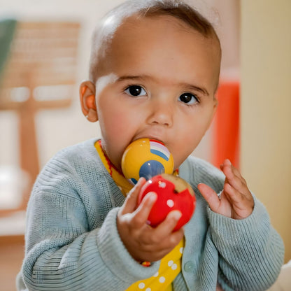 Baby playing with colorful Dachshund dog Maracas from Spiegelburg